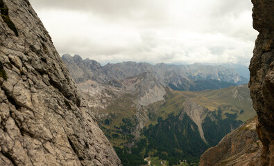 Obraz premium Alpine mountain panorama framed by limestone cliffs in Dolomites mountains Italy