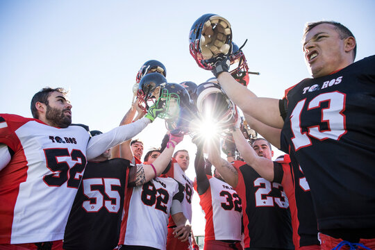 American football players celebrating the victory after the match