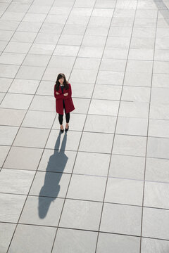 View from above of walking modern businesswoman standing on concrete floor