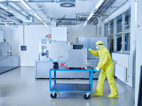 Chemist working in industrial laboratory clean room
