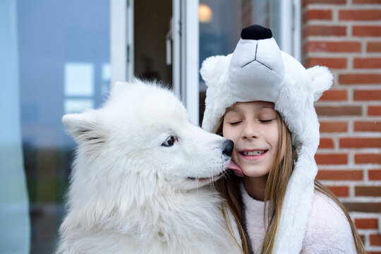 Portrait of girl on terrace with her white dog