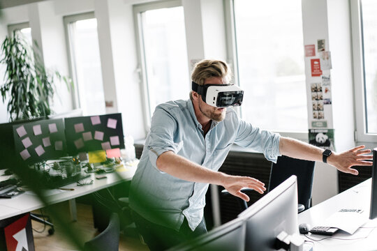 Businessman wearing VR glasses in office