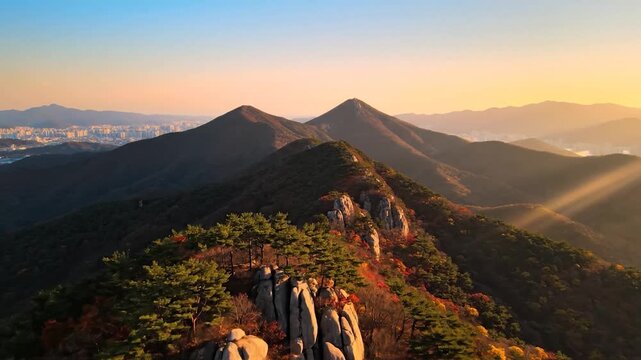 Majestic mountain peaks and y ridges bathed in golden light at sunset