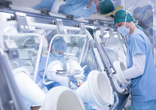 Scientists processing human tissue in insulator laboratory