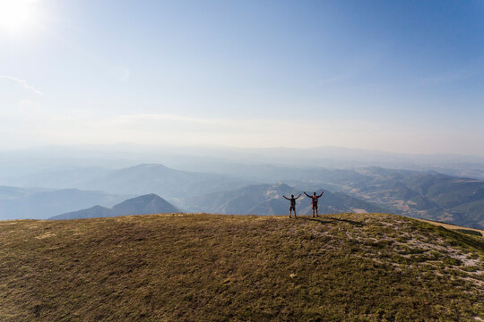 Italy, Monte Nerone, two hikers on top of a mountain enjoying the view