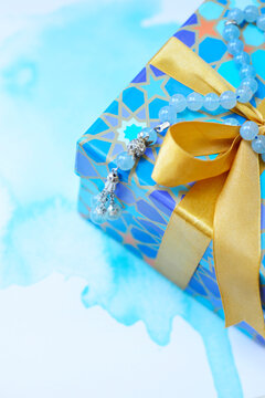 Close up of a beautiful blue color gift box and an Islamic rosary with a modern set up. Eid celebrations and gift ideas.  