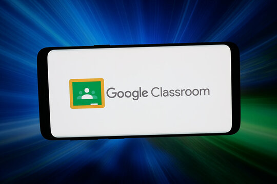 Stuttgart, Germany - 03-02-2026: In this photo illustration, the logo of hybrid learning platform Google Classroom is displayed on a smartphone in front of abstract background on computer screen.