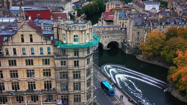 Aerial view of Pulteney Bridge and the River Avon weir with historic Georgian architecture in Bath Somerset England