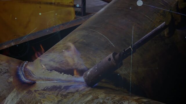 Welder's gloved hands lighting torch and welding Y-joint pipe, dots linking weld for shipyard