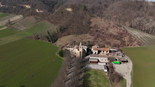 Chiesa di Sant Ilario Vescovo within rural hamlet of Chiavenna Rocchetta near Lugagnano Val d&rsquo;Arda, Province of Piacenza, Emilia-Romagna, Italy &mdash; static aerial