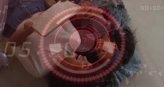 Partners sharing book on blanket, turning page and activating red HUD circling pair for technology