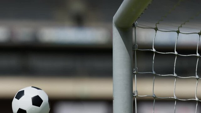 Close-up of a soccer ball hitting the post