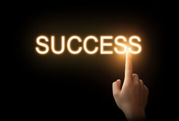 a hand interact with golwing text "SUCCESS"
