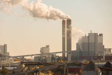 A industrial complex with smoking chimneys. Environmental pollution. Smoke and emissions from the...