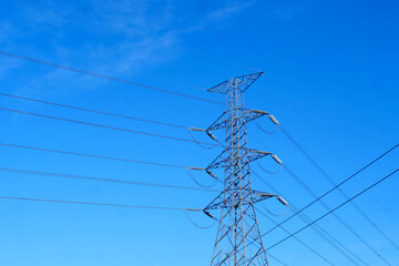 Electric pylon stands tall against clear blue sky