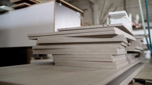 Stack of light wood laminated boards for furniture manufacturing in a workshop