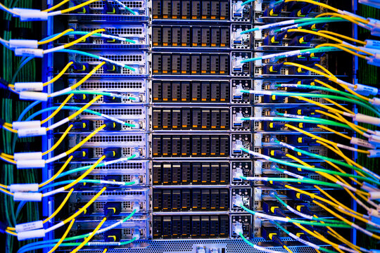 close up of server racks in a data center used for ai with cables and plugs. Concept of hardware and connectivity for AI computing center