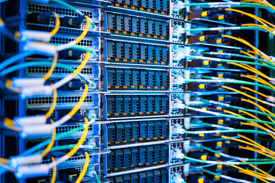 close up of server racks in a data center used for ai with cables and plugs. Concept of hardware and connectivity for AI computing center