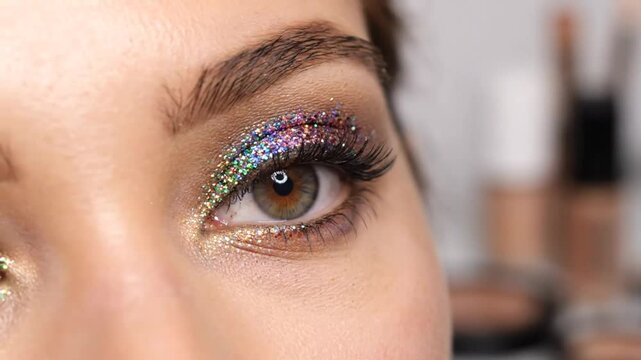 Eye makeup with vibrant colorful glitter applied to the eyelid for a glamorous artistic look