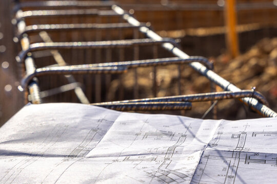 Construction Rebar Framework with Architectural Blueprints