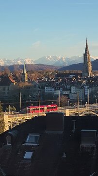 Bern, capital city of Switzerland, view of the oldtown on a winter sunny day with the snow covered Alps in the background. Vertical footage.