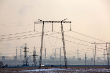 Fototapeta premium Industrial landscape with power transmission towers and lines. Environmental issues.