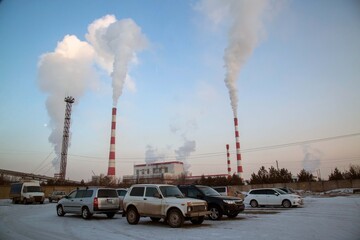 Smoking chimneys of a combined heat and power plant. Coal burning, fossil fuel use. Ecology,...