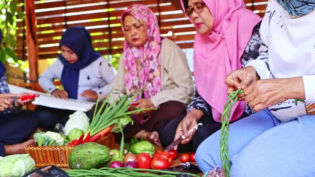 Muslim indonesian women preparing a traditional meal together