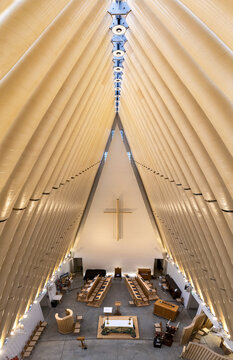 Christchurch, New Zealand - 13 February 2026: Aerial view of the Cardboard Cathedral's soaring interior, where warm light bathes the simple altar and cross.