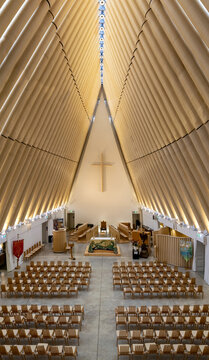Christchurch, New Zealand - 13 February 2026: Aerial view of the Cardboard Cathedral's soaring, light-filled interior, where warm wood tones meet cool concrete floors under a striking triangular roof.
