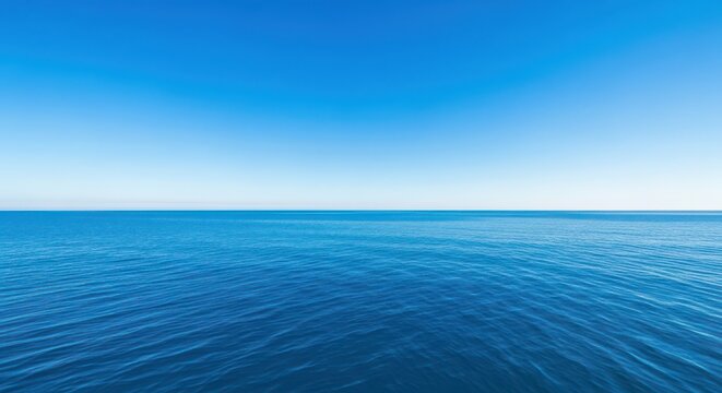 Expansive ultra-wide panoramic vista capturing the massive deep blue ocean stretching endlessly toward the seamless horizon and clear blue sky, deep, horizon, expansive