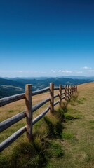 Fototapeta premium Scenic Perspective of a Wooden Fence Line Against a Clear Blue Sky