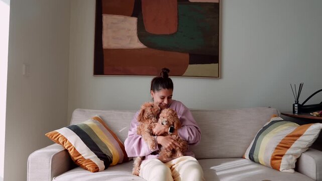 Cheerful woman lovingly trains and plays with puppy in sunny space