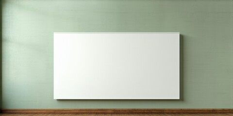 Obraz premium Blank canvas hangs centered on muted green wall. Dark flooring provides contrast. Minimalist aesthetic, simple composition, clean lines present.