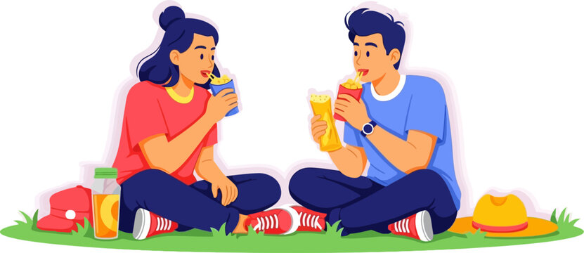 Young couple enjoying picnic on grass