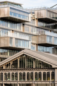 Paris France architecture mixing modern building balcony details with market heritage character creating an urban scene of contrast and local history