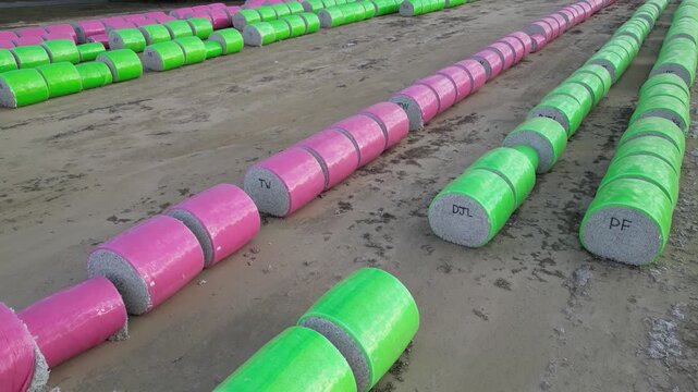 Plastic wrapped upland cotton (Gossypium hirsutum) modules displaying farm identification markings within the Wiregrass region illustrating traceability and harvest storage logistics, descending shot