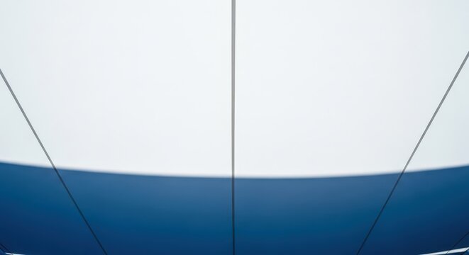 Large white fabric stretched taut, creating a refreshing shaded area above an outdoor patio during the bright summer day, shelter, sunny, resort