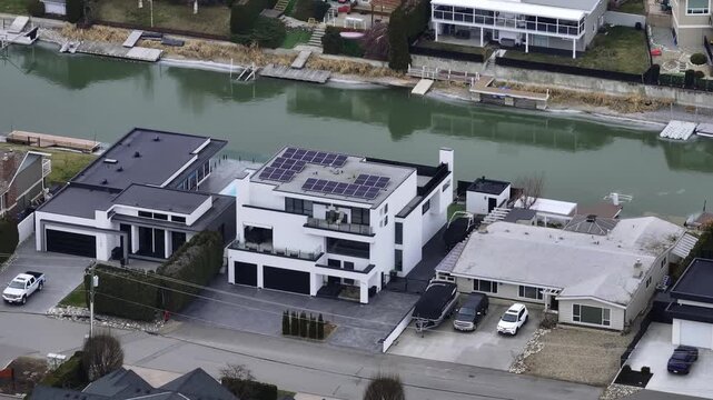 Houses by the water with solar panels on the roof