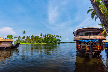 Panoramic river view and traditional house boat in Kerala's Backwaters, India.