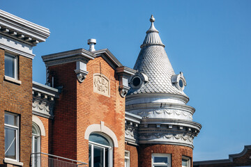 Quebec City, Canada - August 23, 2025: Historic brick building with decorative turret and architectural details in Quebec City, Canada © Andrei Antipov