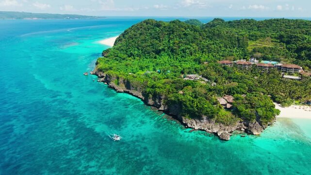 Cinematic aerial of blue sea and rocky shore of Boracay Malay Aklan Philippines