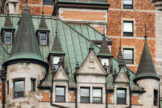 Quebec City, Canada - August 23, 2025: Close-up architectural details of Fairmont Le Chateau Frontenac hotel towers, green copper roofs, turrets and brick stone facade elements