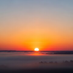 Obraz premium Glorious morning scene over the misty landscape as the vibrant orange sun crests the horizon, signaling the start of a new day, golden, dramatic, majestic