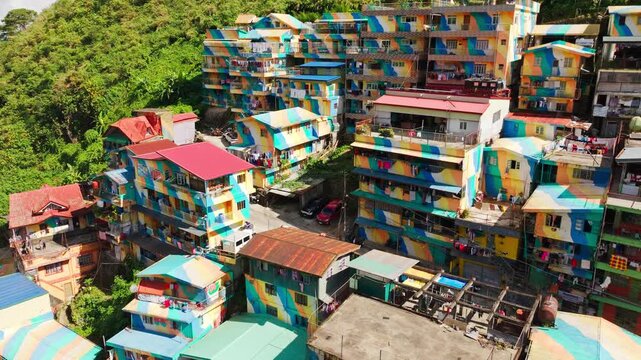 Drone reveals colorful hillside homes of STOBOSA artwork in bright sunlight