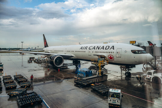 Montreal, Canada - August 24, 2025: Air Canada aircraft being loaded with cargo at the gate at Montreal Trudeau International Airport