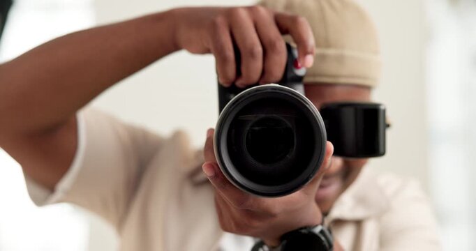 Man, photographer and lens of camera in studio for production, photoshoot and capture picture. Face, male person and focus with equipment for photography, filming and videography for content creation