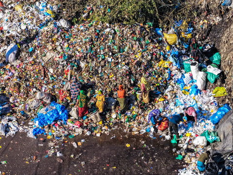 Chattogram, Bangladesh - 25 November 2025: Aerial view of Anondobazar Landfill reveals a stark tapestry of waste, where vibrant colors clash with the grim reality of discarded materials.
