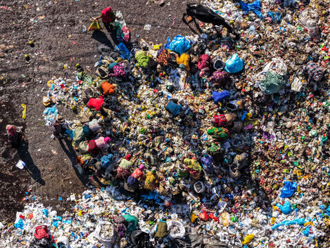Chattogram, Bangladesh - 25 November 2025: Aerial view of Anondobazar Landfill where vibrant colors of clothing pop against the muted tones of the waste.