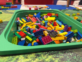 Naklejka premium Colorful building bricks in green tray